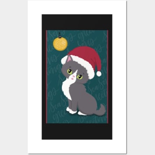 Cute Christmas card with a little kitten in a Christmas hat looking at a bauble. Posters and Art